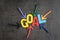 Business success target or goals concept, colorful wooden alphabets GOAL at the center with pointing arrow magnet on black