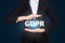 Business in suit protecting word GDPR with hands, General Data P