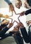 Business superstars. Low angle shot of a group of young businesspeople joining their hands in a modern office.