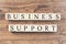 Business support text on wooden background