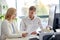 Business team discussing papers at office table