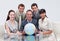 Business team holding a terrestrial globe