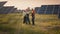 Business team of industrial technicians walking through solar park outside. Construction of concentrated solar power