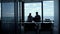 Business team silhouettes talking at sea clouds view. Two managers work laptop