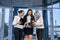 Business team with tablets posing outside office building. Three ladies looking directly on tablet screen