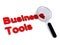 Business tools with magnifying glass on white