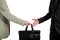 Business transfer. handover of a suitcase partners