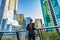 Business woman in city center looking at view of skyline skyscrapers in Vancouver downtown , Canada. Businesswoman from