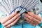 Business woman counting money in hands. Handful of money. Offering money. Women`s hands hold money denominations of 100 dollars.