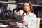 Business woman enjoying aromatic cup of coffee and reading latest news on tablet