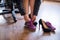 A business woman exchanges high heels for comfortable shoes in the workplace. A close-up of female hands takes off her