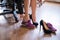 A business woman exchanges high heels for comfortable shoes in the workplace. A close-up of female hands takes off her