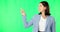 Business woman, face and pointing with green screen, list or review option by studio background. Happy businesswoman