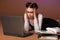 Business woman in front of a laptop with folders of papers