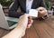 Business woman give business card for customer in coffee shop.