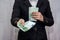 Business woman gives euro banknote. 100 euros in the hands.