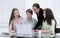 Business woman and group of young employees using laptop to work