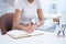 Business woman, hand and writing notes at a office desk with creative writer information. Content agency, paperwork and