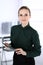 Business woman headshot in modern office. Secretary or female lawyer using tablet computer while standing straight