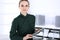 Business woman headshot in modern office. Secretary or female lawyer using tablet computer while standing straight