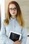 Business woman headshot in sunny office. Unknown businesswoman standing straight with tablet computer. Young accountant