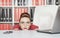 Business woman hiding behind table and afraid