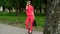 business woman on high heels in red suit and sunglasses