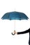 Business woman is holding blue umbrella.