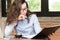 Business woman holding document in her hands.Young pretty teacher checking the tests