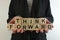 Business woman holding text think forward from wooden blocks