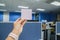 Business woman holds mock up postit sticky note in office with left hand