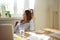 Business woman in home office looking away thinking