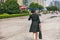 Business woman lady walking away on Shanghai city street wearing elegant silk shirtdress for professional work realtor