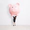 Business woman lift piggy bank