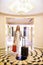 Business woman, luggage and smile in hotel corridor for portrait with suit, handbag and pride in lobby. Person