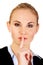 Business woman making silent sign with finger on lips