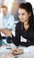 Business woman and man discussing questions while using computer at workplace in sunny office