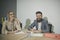 Business woman and man smile at office desk. Business girl and bearded man have meeting in office, concentration at work