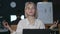 Business woman meditating in yoga pose front computer table in night office