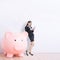 Business woman with piggy bank