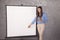 Business woman pointing to a place on the board, copy space, poi