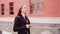 Business woman posing. Young woman in glasses, business suit on city street.