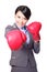 Business woman punching by boxing gloves