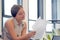 Business woman reading a document in office workspace