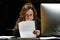 Business woman reading a document in office workspace