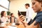 business woman reading message on mobile phone. presentation in background.