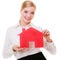 Business woman real estate agent holding red paper house.