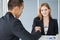 business woman shaking hands with businessman in office . girl looking at camera