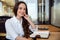 Business woman sitting in her office, young entrepreneur, smiling cheerful, energetic, enthusiastic creative professional