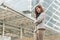 Business woman standing arms crossed at stairs in modern city.Copy space